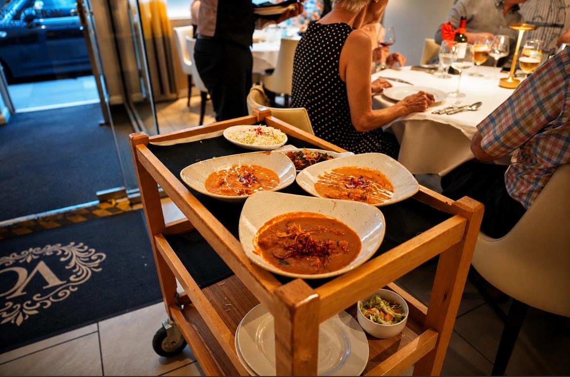 Freshly prepared curries arriving for tableside service